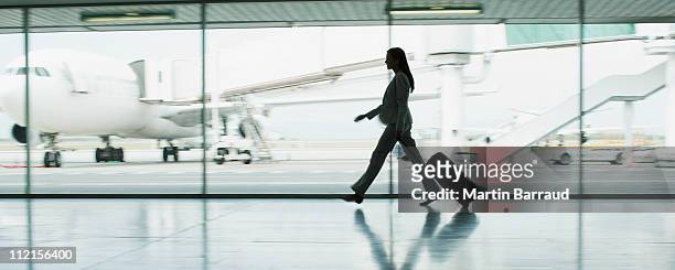 businesswoman with suitcase in airport - airport stock pictures, royalty-free photos & images