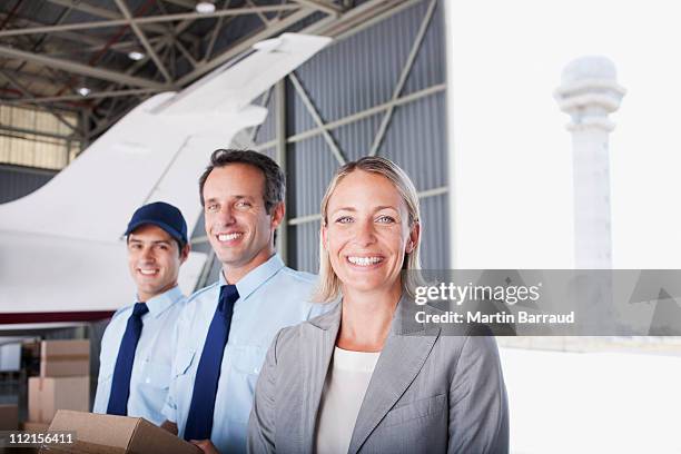 businesswoman and workers standing in hangar - airport ground crew uniform stock pictures, royalty-free photos & images