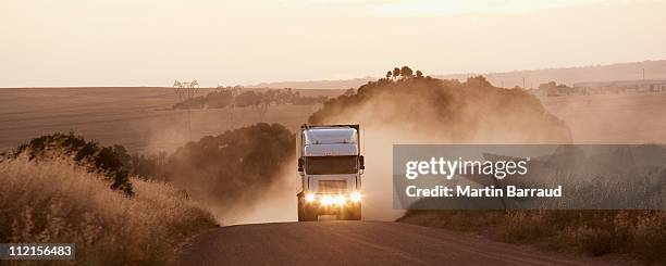 semi-truck driving on dirt road - african lorry stock pictures, royalty-free photos & images