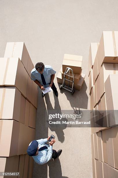workers standing with boxes - postman stock pictures, royalty-free photos & images