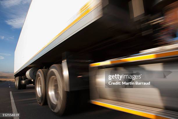 semi-truck speeding on remote road - african lorry stock pictures, royalty-free photos & images