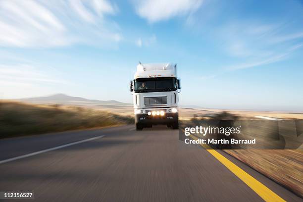 semi-truck speeding on remote road - african lorry stock pictures, royalty-free photos & images