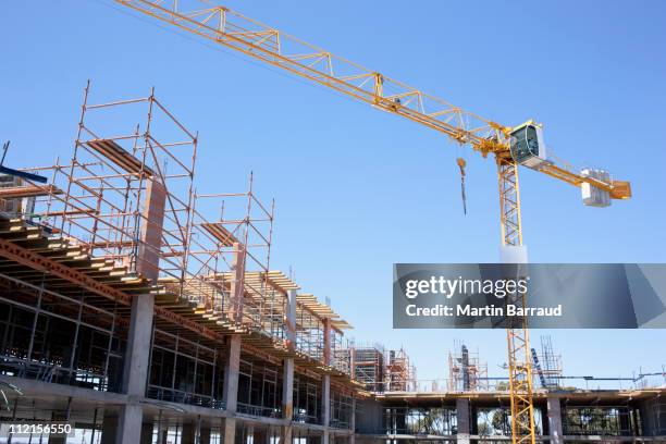 crane on construction site - crane stock pictures, royalty-free photos & images