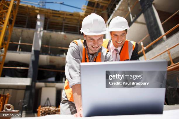 construction workers using laptop on construction site - program manager stock pictures, royalty-free photos & images