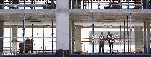 construction workers standing together on construction site - worker construction site stock pictures, royalty-free photos & images