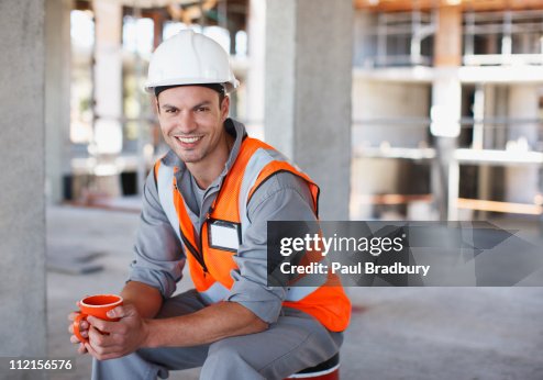 Construction worker having coffee break on construction site Construction worker having coffee break on construction site