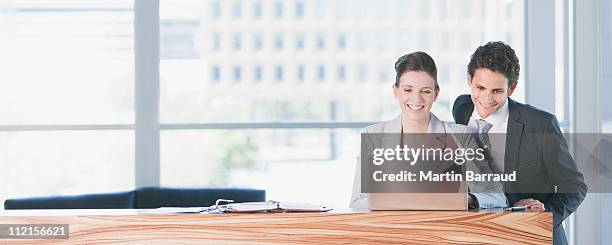 business people looking at laptop in office - person waist up stock pictures, royalty-free photos & images
