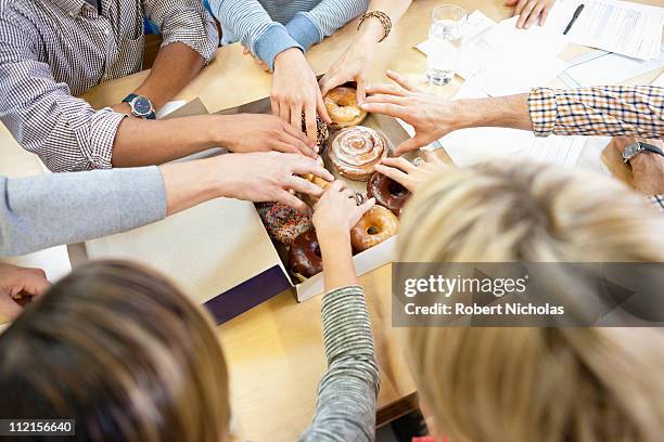 business people taking donuts - donut man bildbanksfoton och bilder