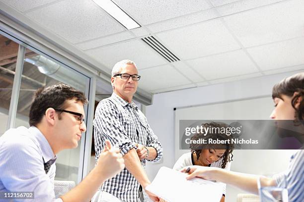 business people working together in office - sleeve roll stock pictures, royalty-free photos & images