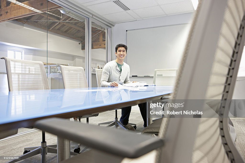 Businessman sitting alone in conference room