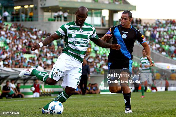 Felipe Baloy of Santos struggles for the ball with Aaron Padilla of Puebla during a match as part of the Clausura 2011 at Corona Stadium on April 13,...