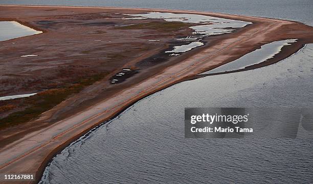 Sand berm built to capture oil from the BP spill is seen at an oil cleanup site in Barataria Bay April 13, 2011 in Barataria Bay, Louisiana....