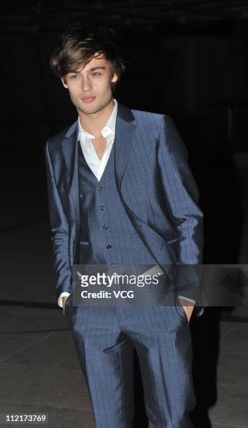 English actor Douglas Booth poses for photos as he arrives at the corporate event of the fashion apparel company Burberry at Sparkle Roll Plaza on...