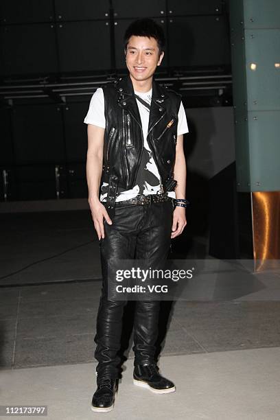 Jia Nailiang poses for photos as he arrives at the corporate event of the fashion apparel company Burberry at Sparkle Roll Plaza on April 13, 2011 in...