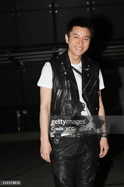 Jia Nailiang poses for photos as he arrives at the corporate event of the fashion apparel company Burberry at Sparkle Roll Plaza on April 13, 2011 in...