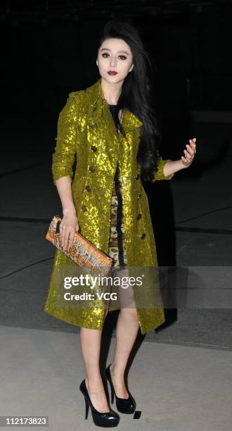 Fan Bingbing poses for photos as she arrives at the corporate event of the fashion apparel company Burberry at Sparkle Roll Plaza on April 13, 2011...