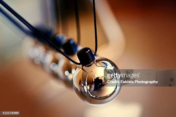 the lens that rocked the cradle! - newtons cradle stock pictures, royalty-free photos & images