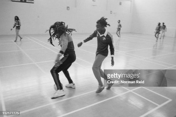 Jamaican singer-songwriter Bob Marley being challenged by Jamaican musician Trevor Bow, during a football match between a team led by Marley and...