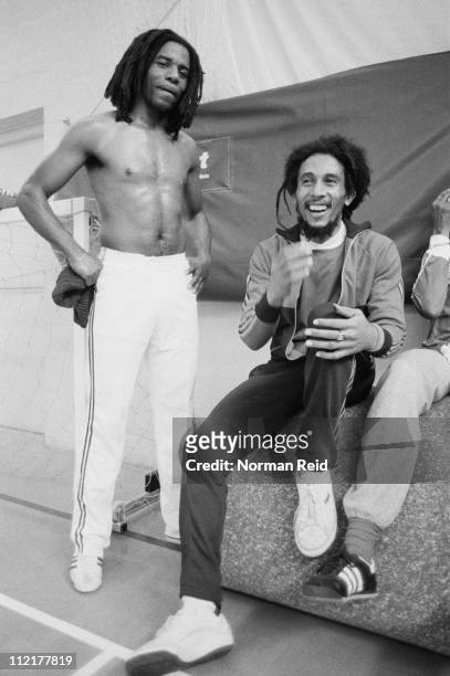 Jamaican singer-songwriter Bob Marley takes a break with fellow reggae artist Eddy Grant during an amateur football match, Hammersmith Leisure...