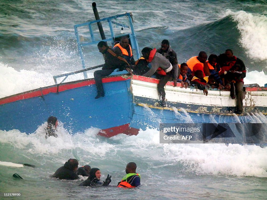 Rescuers help people in the sea after a