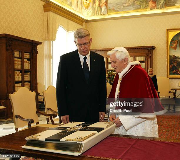 Pope Benedict XVI exchanges gifts with visiting President of Latvia Valdis Zatlers during a meeting at his private library on April 14, 2011 in...