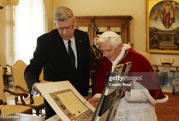 Pope Benedict XVI exchanges gifts with visiting President of Latvia Valdis Zatlers during a meeting at his private library on April 14, 2011 in...