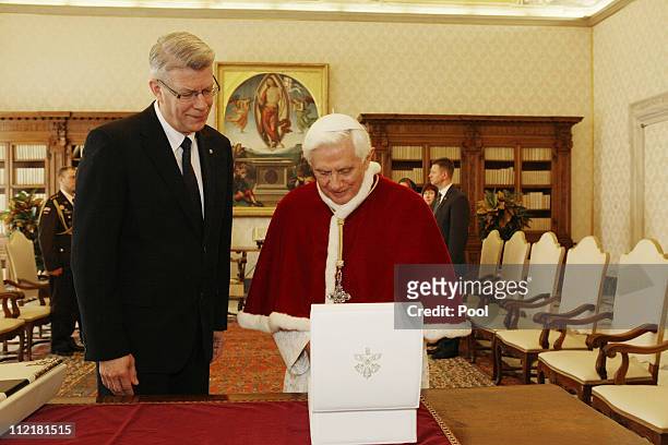 Pope Benedict XVI exchanges gifts with visiting President of Latvia Valdis Zatlers during a meeting at his private library on April 14, 2011 in...