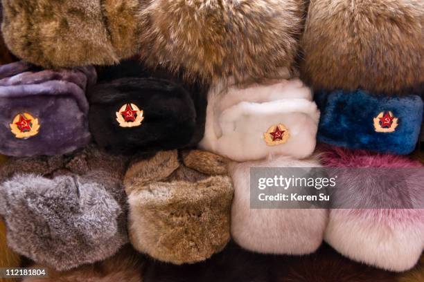 selling fur hats with red army badges - russian fur hat stock pictures, royalty-free photos & images