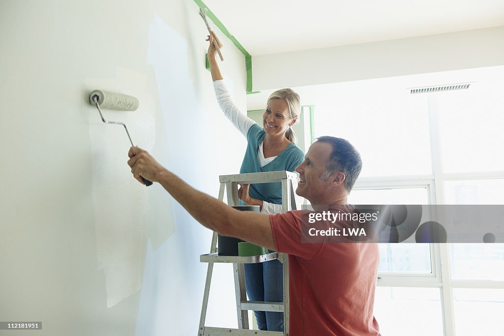 Couple Painting Wall Together