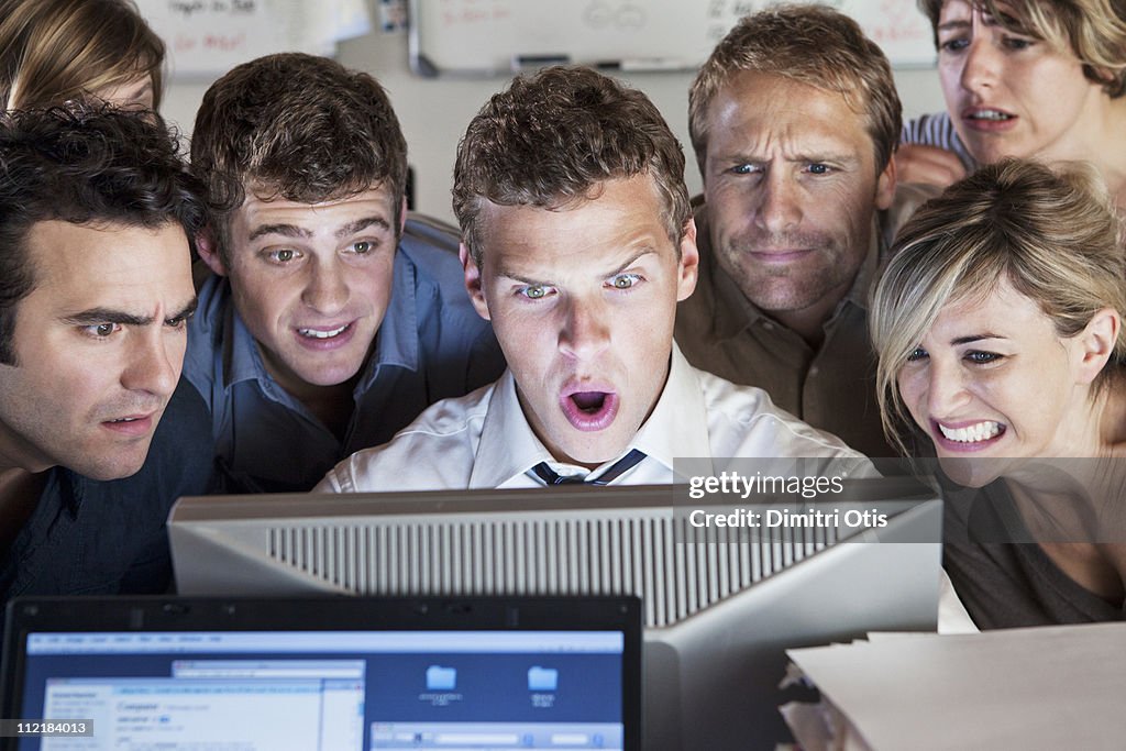 Group of people looking shocked at computer screen