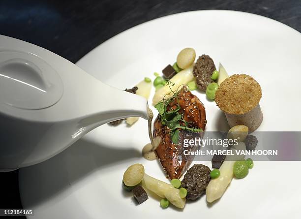 Picture taken on April 14, 2011 shows a plate with Dutch asparagus, foie gras, morels and peas, made by chef Paul van de Bunt, of the two-star...