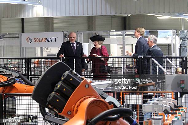 Queen Beatrix of the Netherlands , and CEO of Solarwatt Frank Schneider attend a guided tour of a company for solar modules named Solarwatt on April...