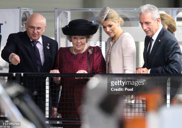 Queen Beatrix of the Netherlands , Princess Maxima , Saxony's Prime Minister Stanislaw Tillich and CEO of Solarwatt Frank Schneider attend a guided...