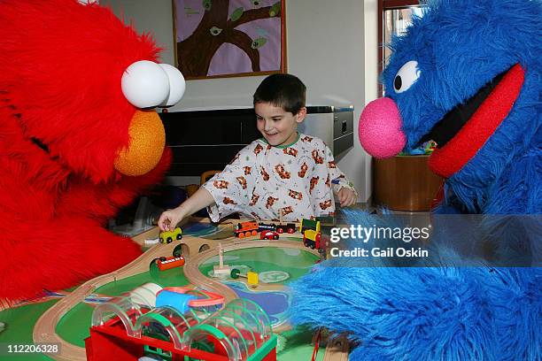 Sesame Street Live stars Elmo and Grover bring sunny days to Aiden at Children's Hospital Boston on April 14, 2011 in Boston, Massachusetts.