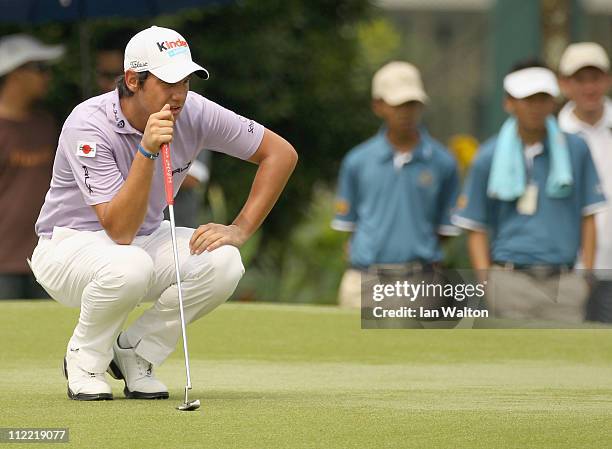 Matteo Manassero of Italy lines up a put on the 9th green during the second round of the Maybank Malaysian Open at Kuala Lumpur Golf & Country Club...