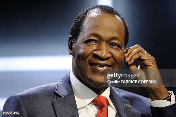 Burkina Faso's President Blaise Compaore adjusts an ear piece prior to a debate on Swiss television on October 22, 2010 in Montreux on the sidelines...