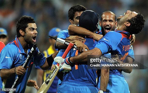 Indian cricketers celebrate after beating Sri Lanka during the ICC Cricket World Cup 2011 final match at The Wankhede Stadium in Mumbai on April 2,...