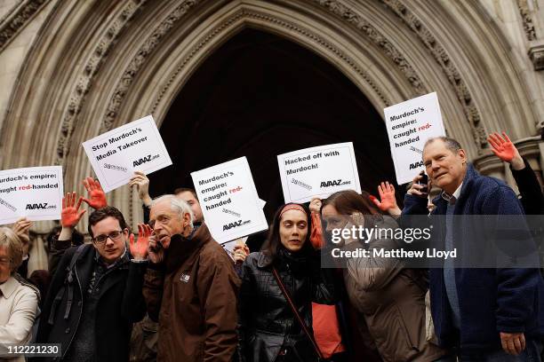Protestors gather outside the Royal Courts of Justice to demonstrate against Rupert Murdoch's News International, which is involved in a trial...