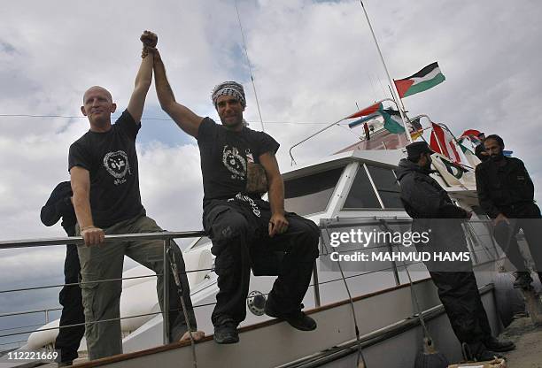 Italian peace activist Vittorio Arrigoni celebrates with a comrade the arrival of 20-metre ship "Dignity" that departed from Cyprus yesterday...