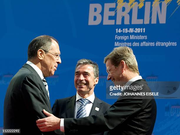 Russian Foreign Minister Sergei Lavrov is welcomed by German Foreign Minister Guido Westerwelle and NATO Secretary General Anders Fogh Rasmussen...