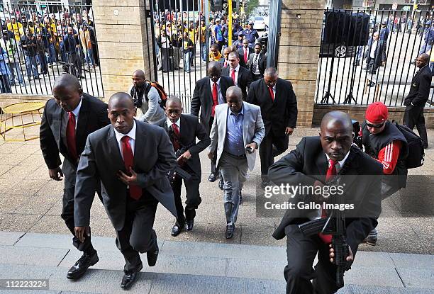 President Julius Malema arriving under heavy security at the Johannesburg high court where he appeared for a fourth day on charges of hate speech for...