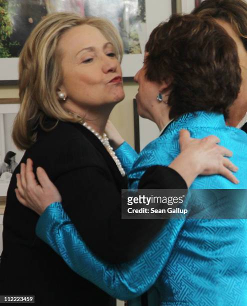 Secretary of State Hillary Clinton embraces High Representative of the European Commission Lady Catherine Ashton at a memorial event for late U.S....
