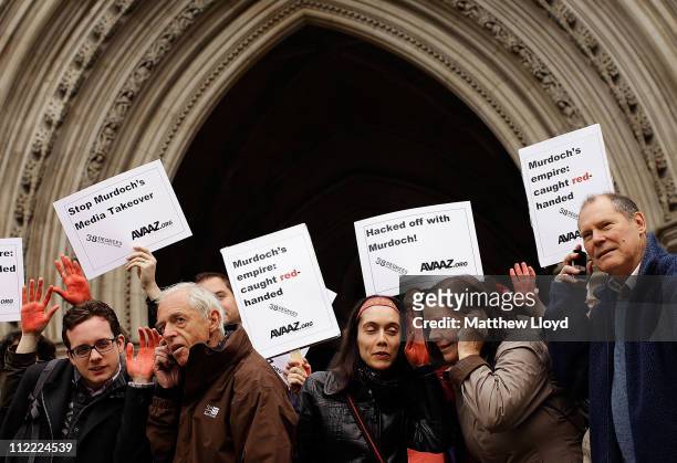 Protestors gather outside the Royal Courts of Justice to demonstrate against Rupert Murdoch's News International, which is involved in a trial...