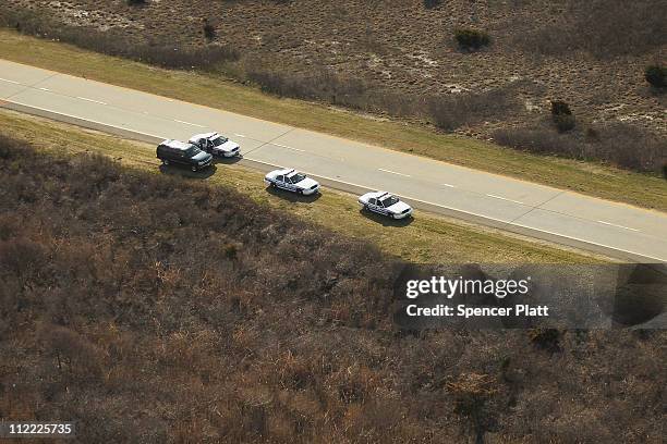An aerial view of police cars near where a body was discovered in the area near Gilgo Beach and Ocean Parkway on Long Island on April 15, 2011 in...
