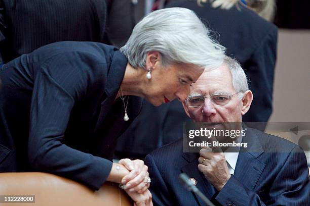 Wolfgang Schaeuble, Germany's finance minister, right, talks to Christine Lagarde, France's finance minister, at the Group of 20 ministers and...