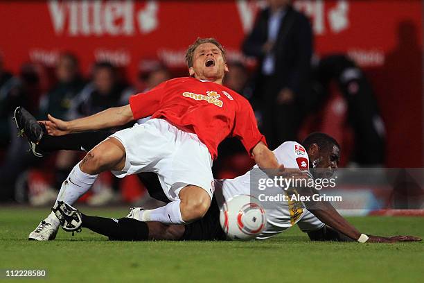 Eugen Polanski of Mainz is challenged by Mohamadou Idrissou of M'Gladbach during the Bundesliga match between FSV Mainz 05 and Borussia M'gladbach at...