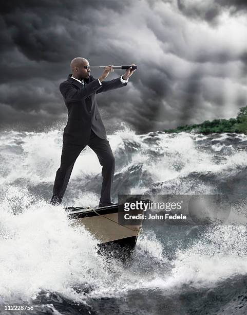 african american businessman using telescope on boat - searching mess stock pictures, royalty-free photos & images