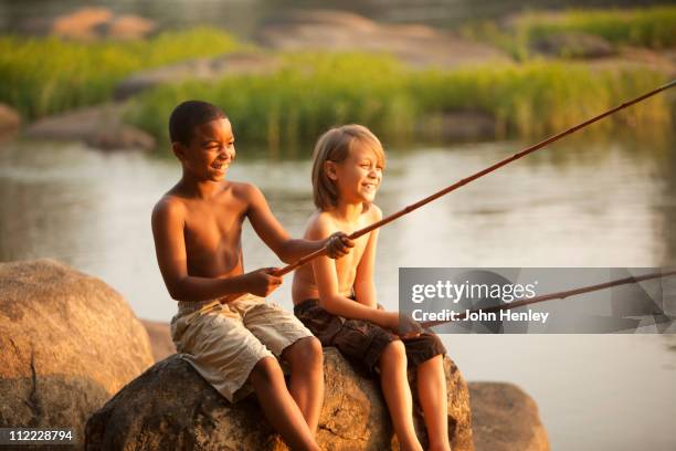 smiling boys fishing together - angel hot stock-fotos und bilder