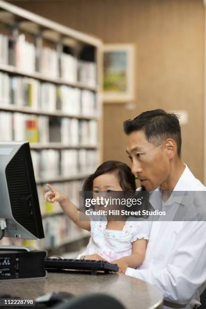 korean father and daughter using computer in library - computer literacy stock pictures, royalty-free photos & images