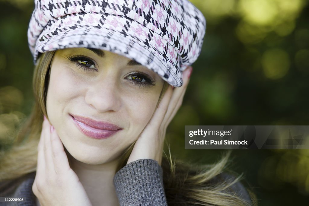 Hispanic woman in fashionable cap